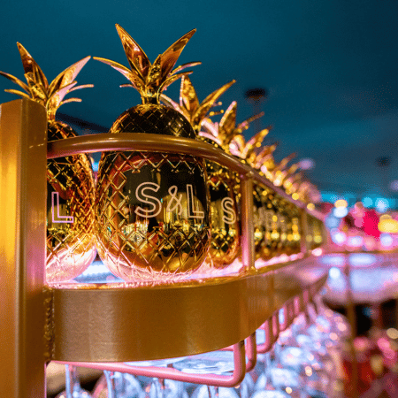 Golden pineapples on a shelf at Slug and Lettuce