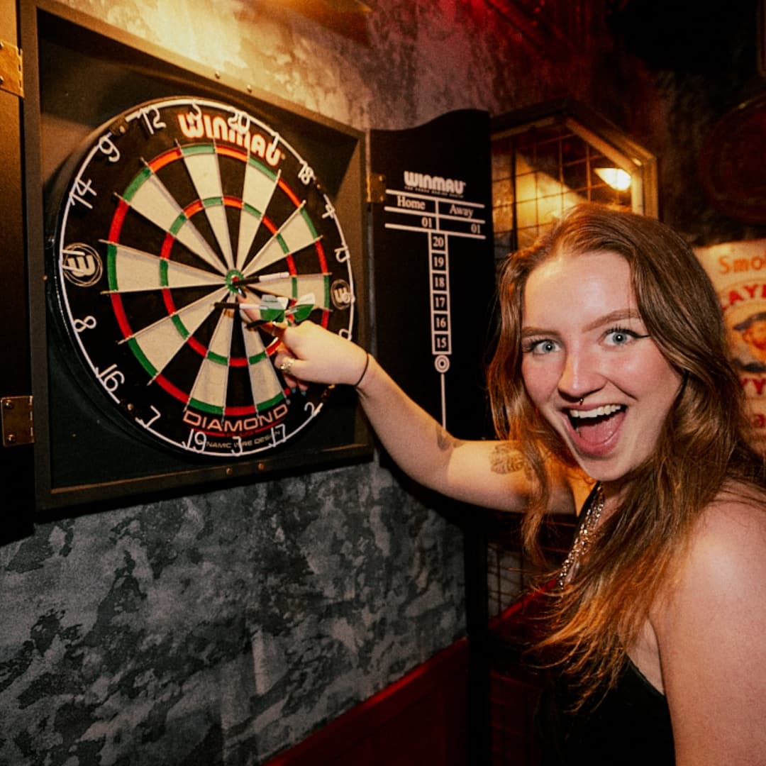 Playing darts at Rita's