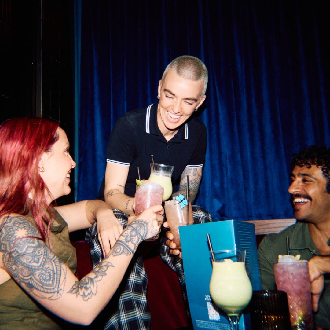 Group enjoying 2-4-1 cocktails at Be At One