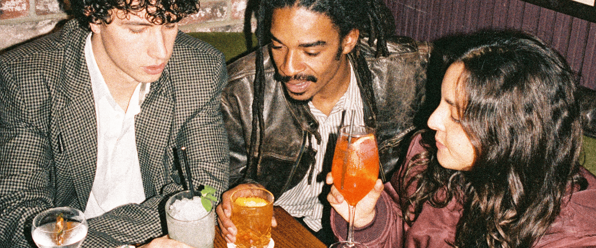 3 people drinking cocktails