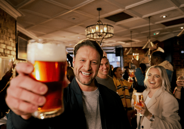 Man smiling in the pub with pint
