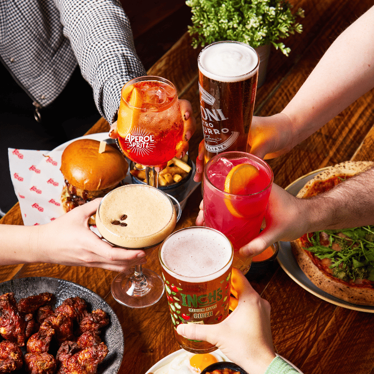 People cheersing drinks at bottomless brunch