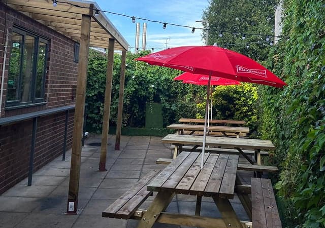 Outdoor drinking area to rear and side of the pub