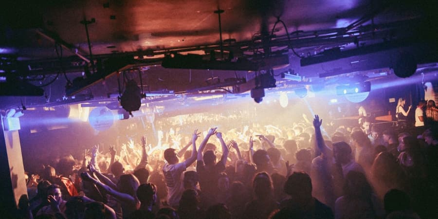 Silhouettes of people dancing in a club