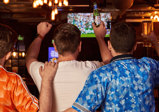People watching football and cheering