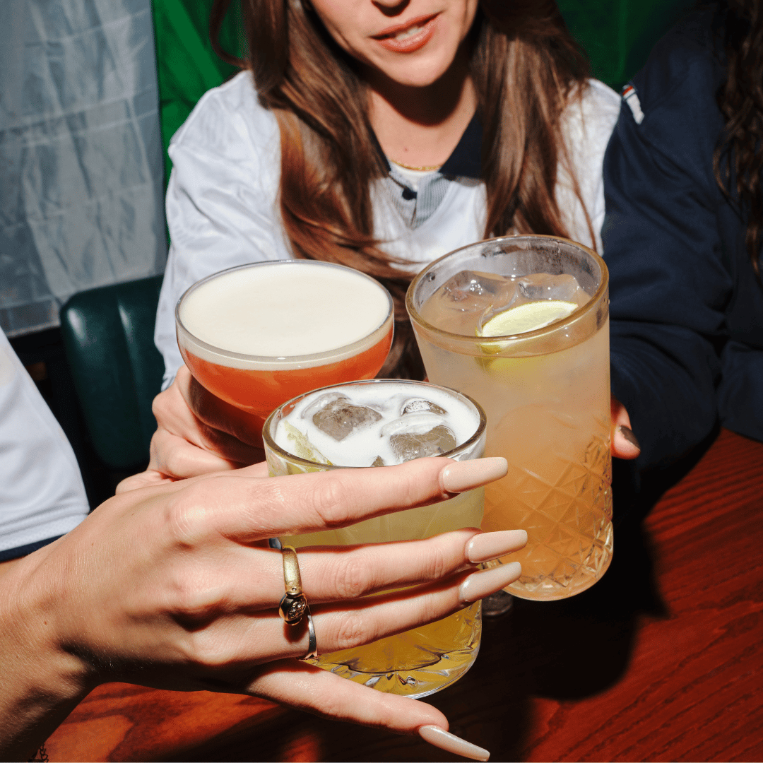 3 people cheersing drinks