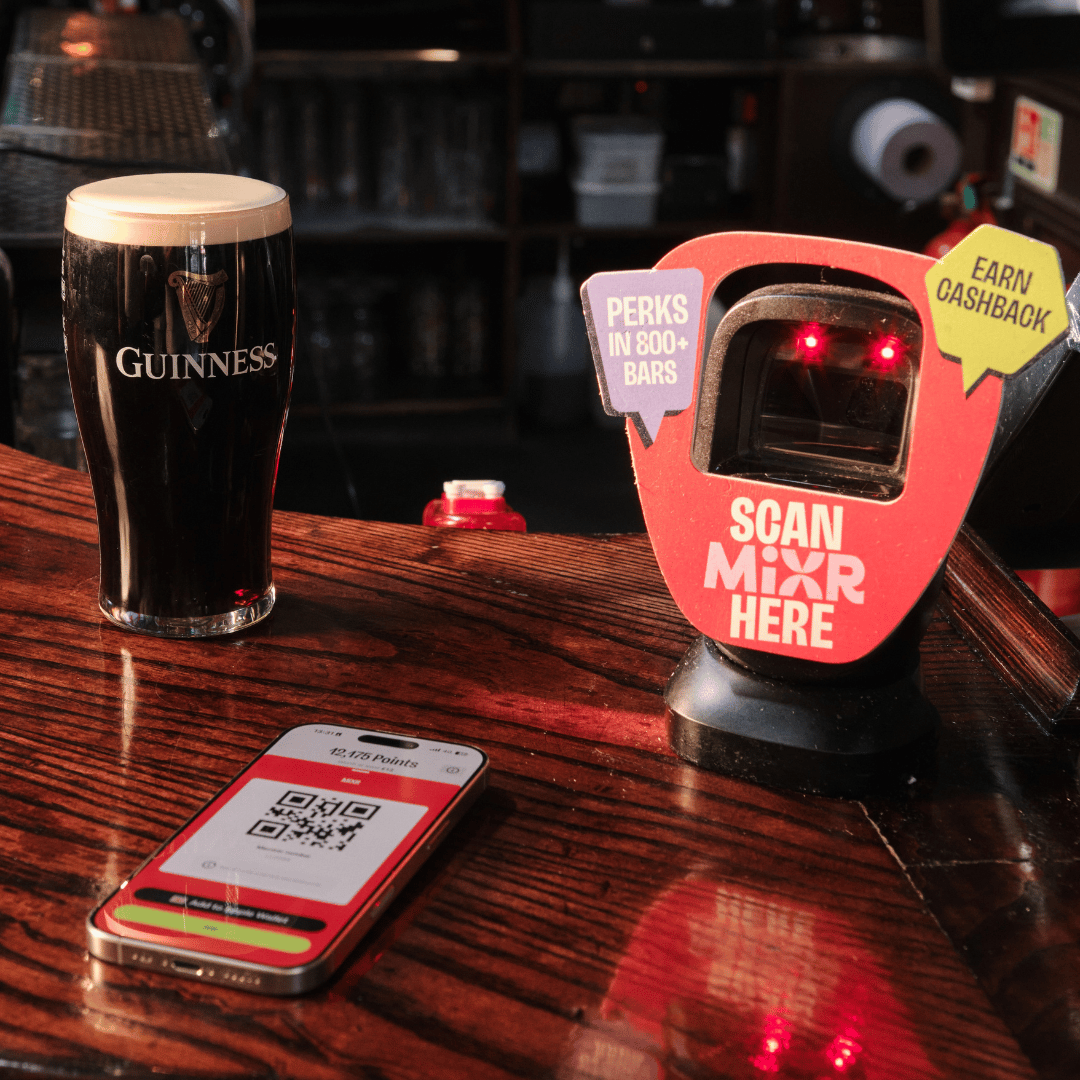Guinness and phone on bar with MiXR app QR code