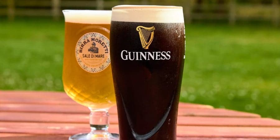 Guinness and pint of lager on beer garden table