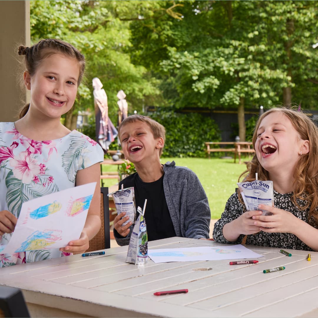 Three children laughing outside