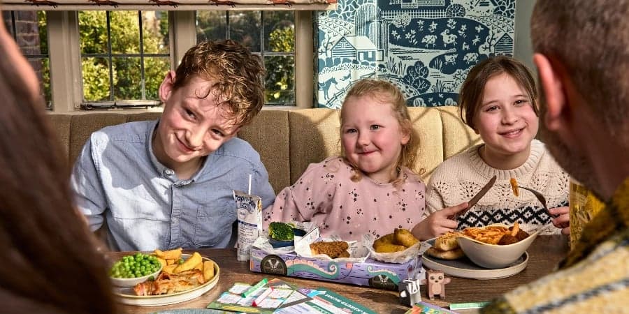 Parents and children enjoying a meal at Heritage Pubs