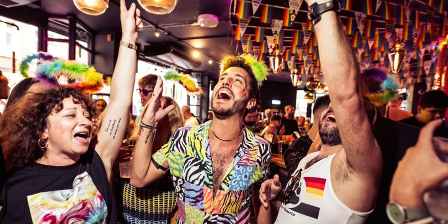 Three people dancing in a bar