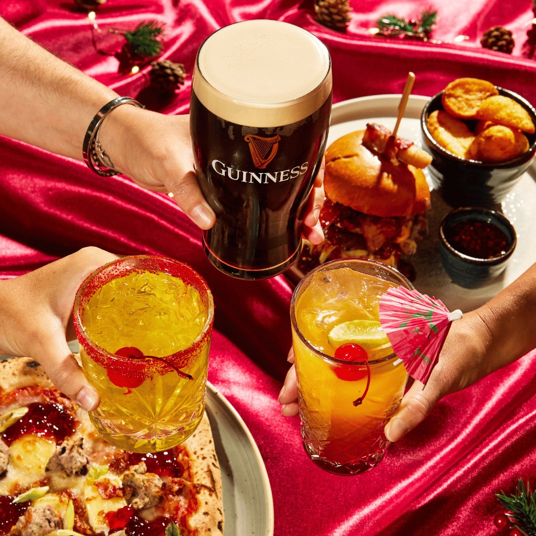 4 people cheersing drinks