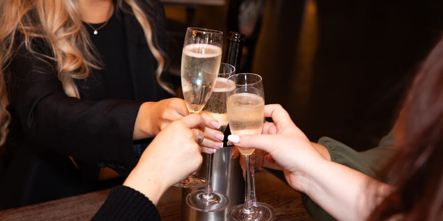 Clinking prosecco glasses