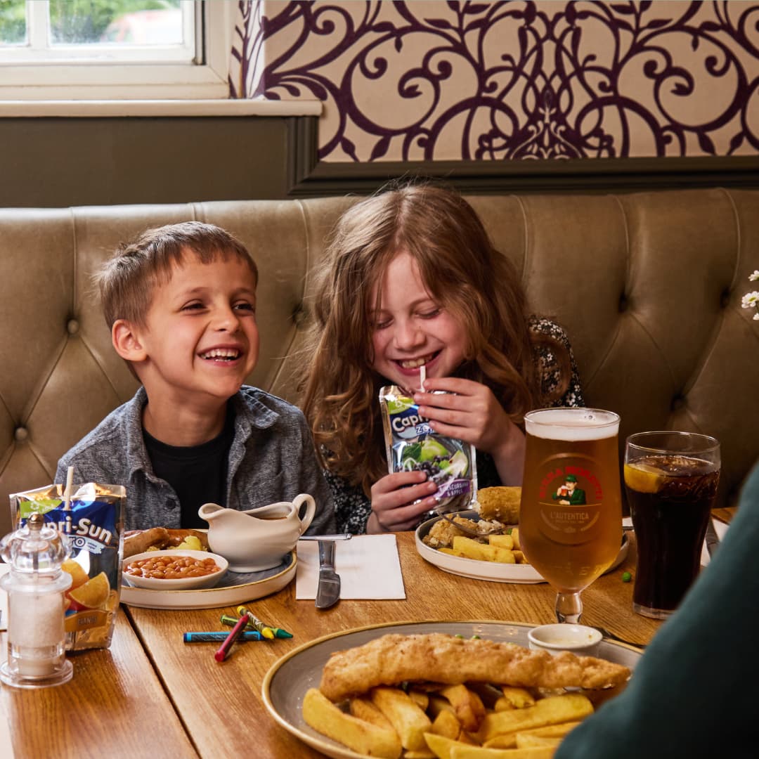 two children eating in a pub