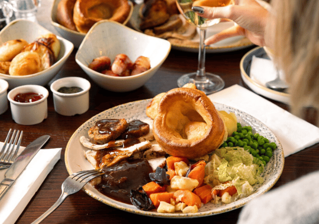 Image of people enjoying a sunday roast in a pub