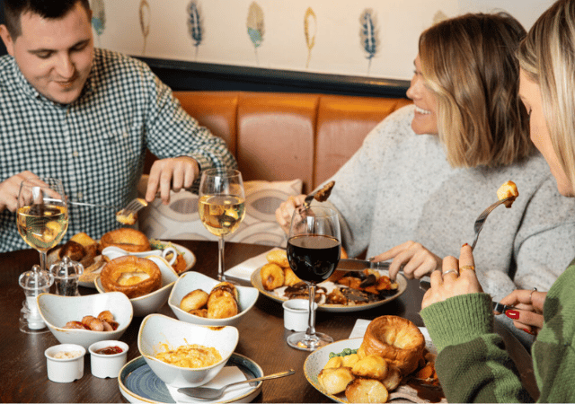 Image of people enjoying a sunday roast in a pub