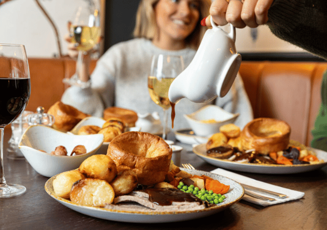 Image of people enjoying a sunday roast in a pub