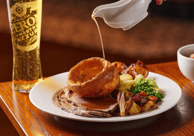 Image of people enjoying a sunday roast in a pub