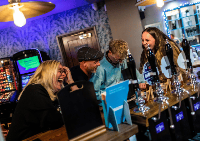 Customers laughing at bar