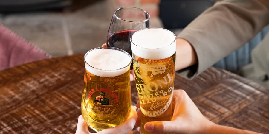 Three people clinking glasses