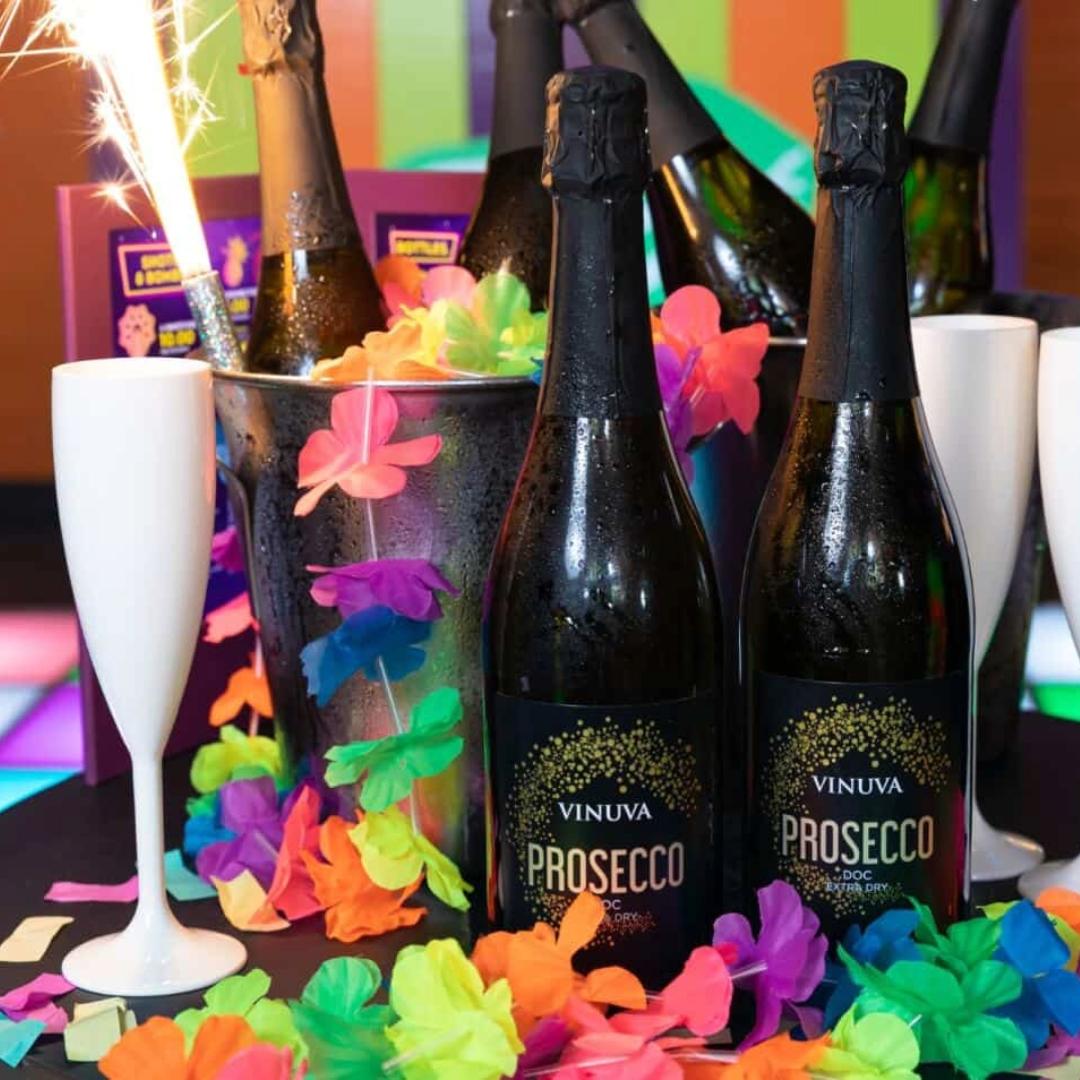 Six bottles of prosecco with sparklers