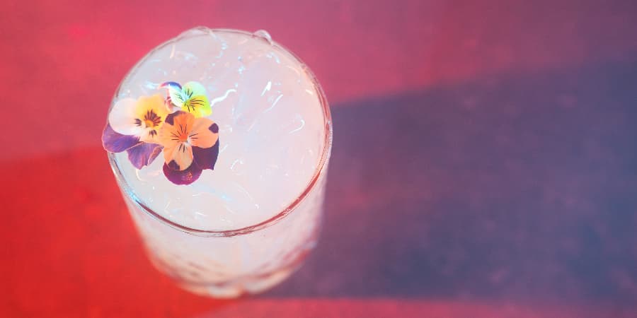 Cocktail topped with edible flowers