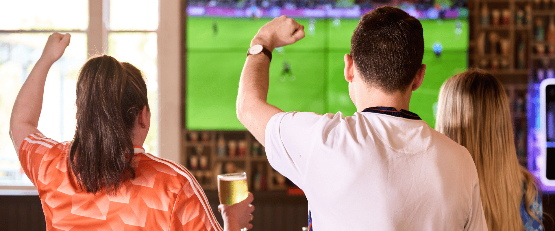 People cheering in front of TV