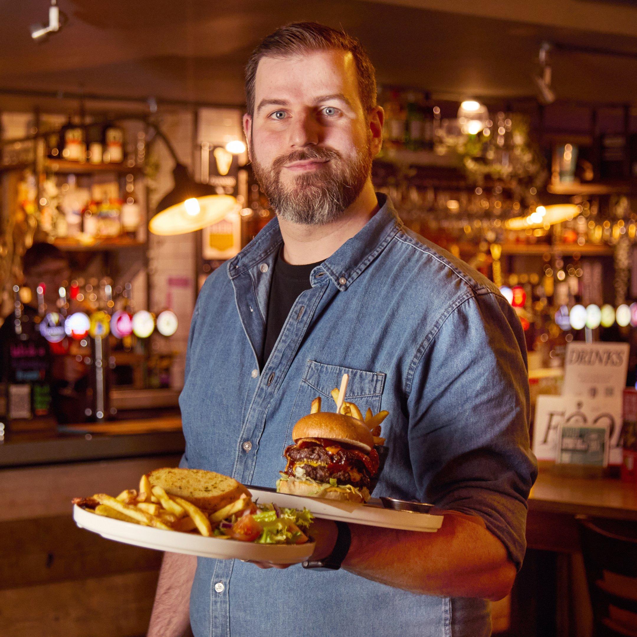 General Manager carrying plates.