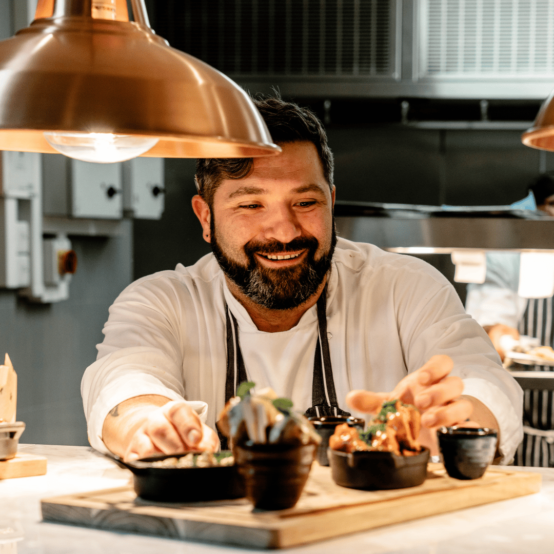 Kitchen Manager working on two dishes