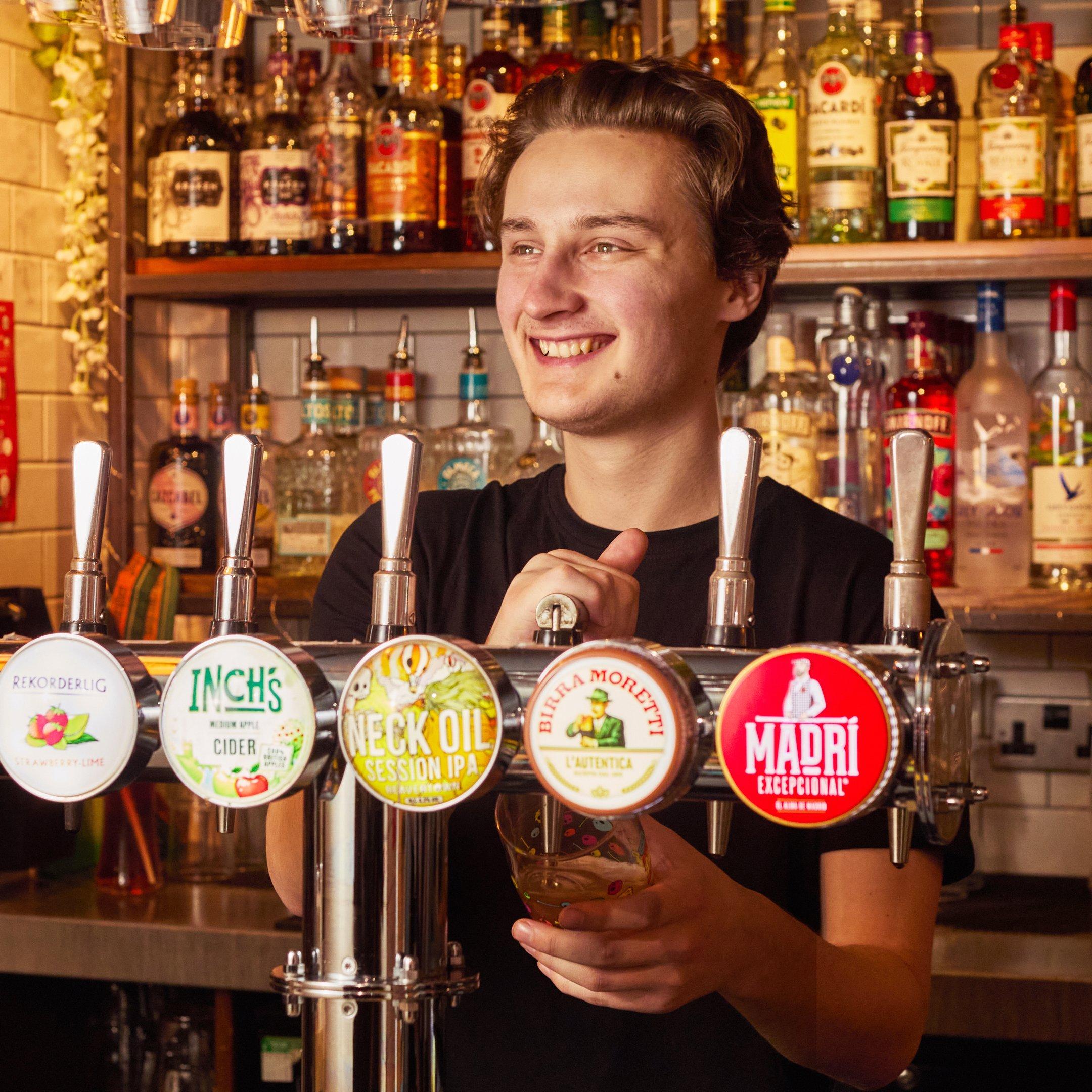 Team Leader pouring a pint behind the bar.