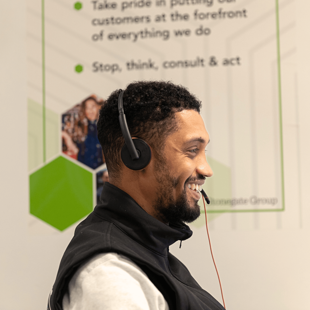 Customer Contact Centre team member wearing a headset and smiling.