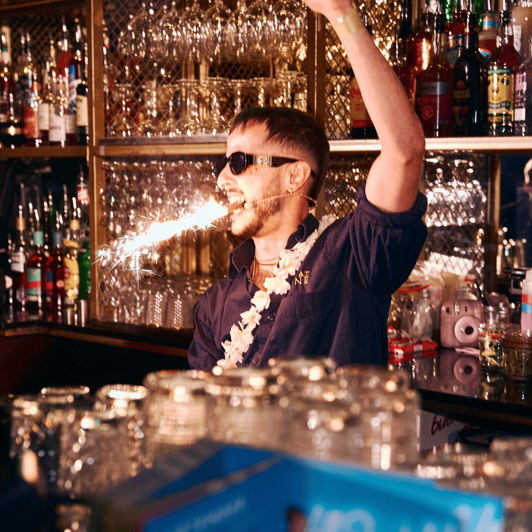 Bartender with sparkler in his mouth