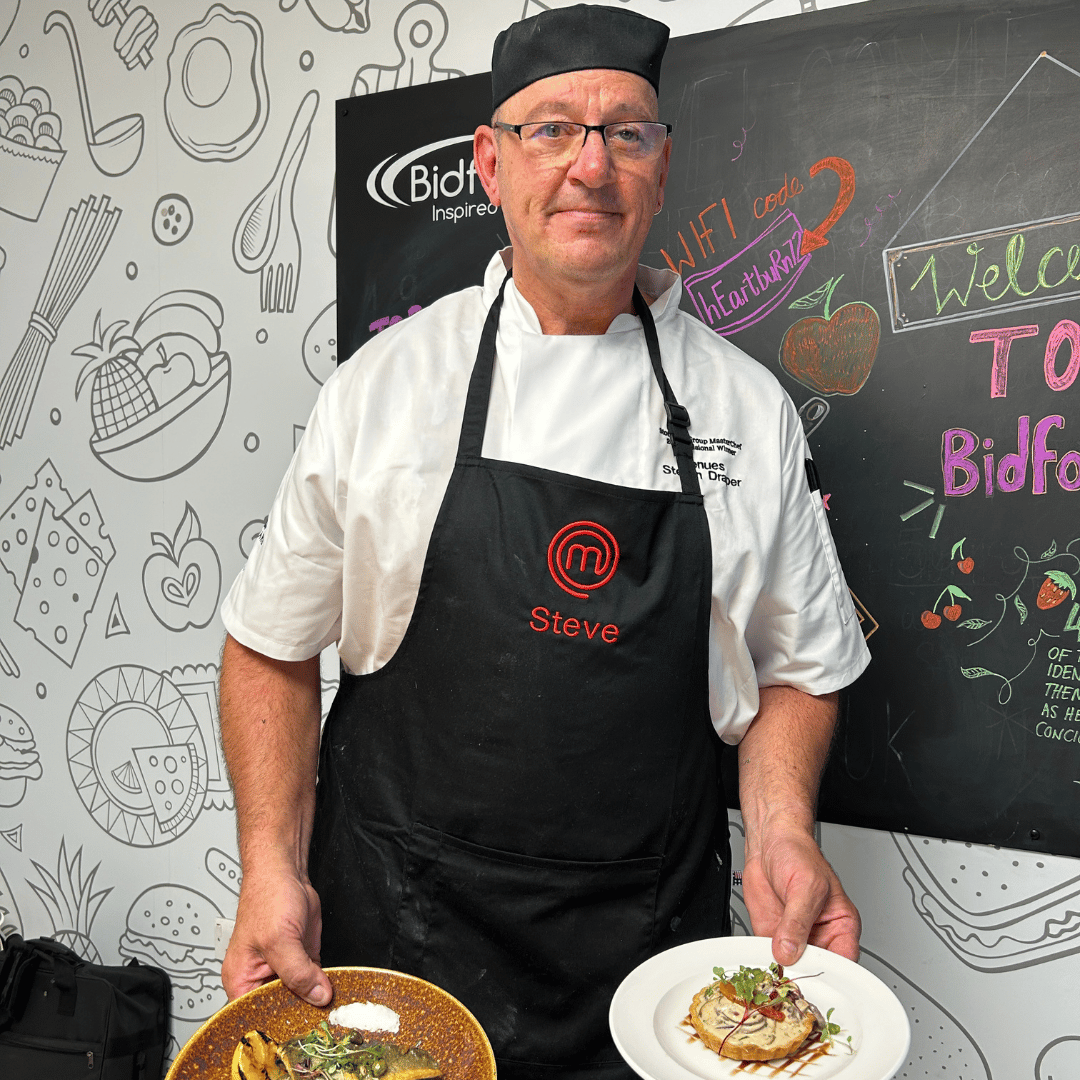Masterchef finalist, Steve holding his two final dishes