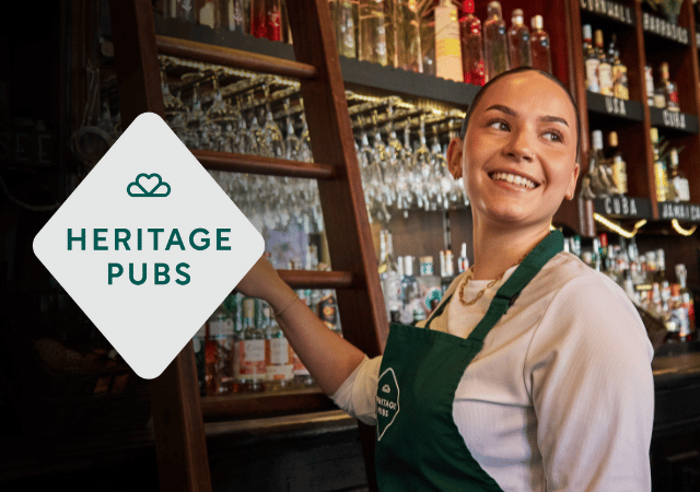 Heritage Pubs logo overlaid on image of a Heritage team member smiling to camera.