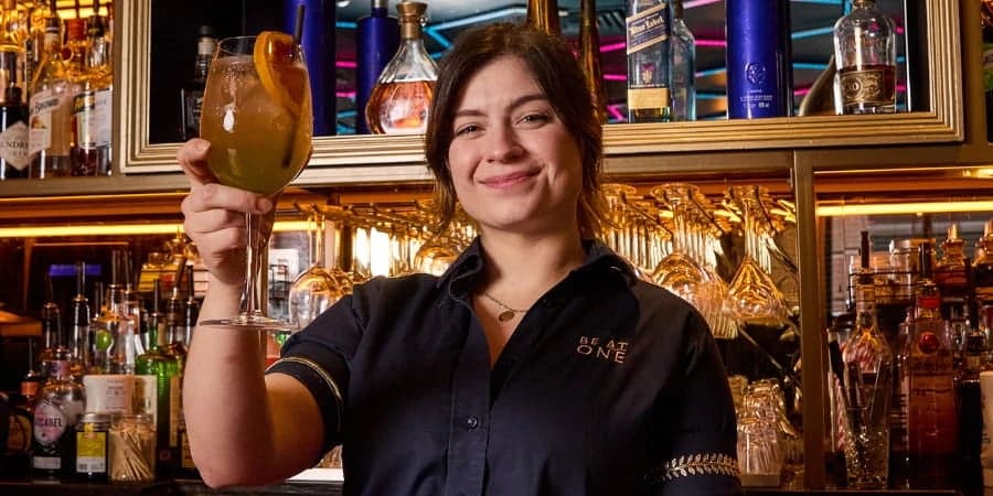 Best in Glass Winner, Lena posing with their cocktail.