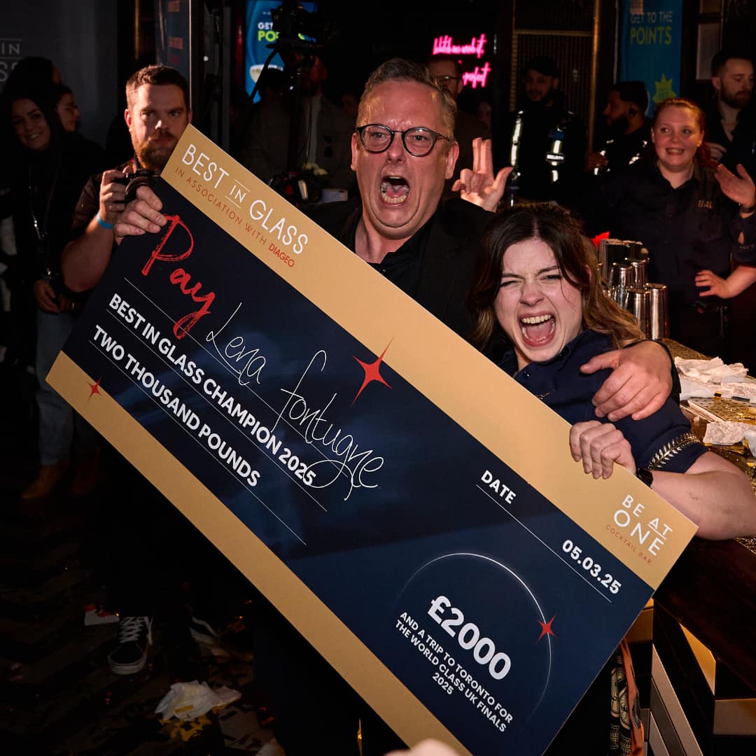 Winner, Lena celebrating with a cheque.