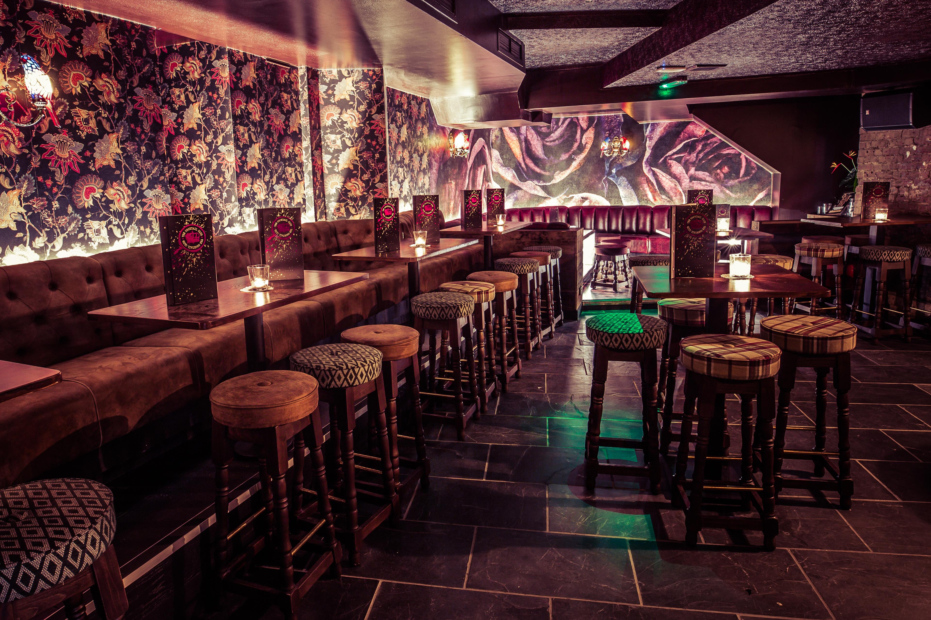 Bar area with stool seating and floral walls