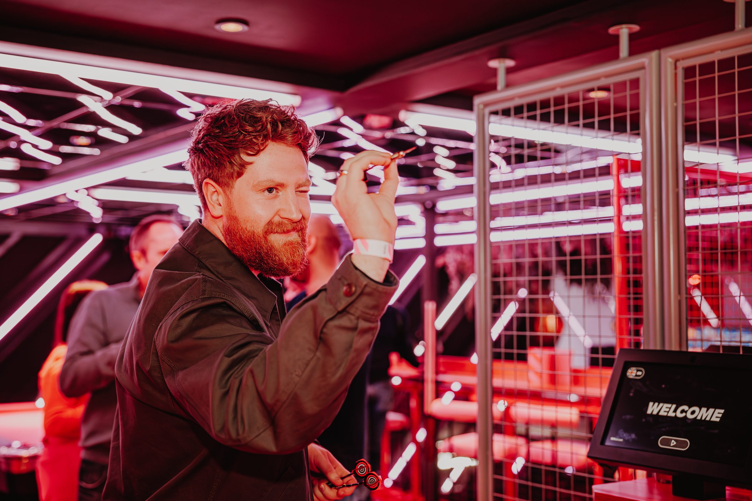 A customer playing smart darts at Playbox in Croydon