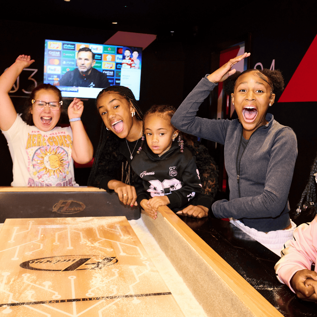 A group of children playing shuffleboard at PLAYBOX in Croydon
