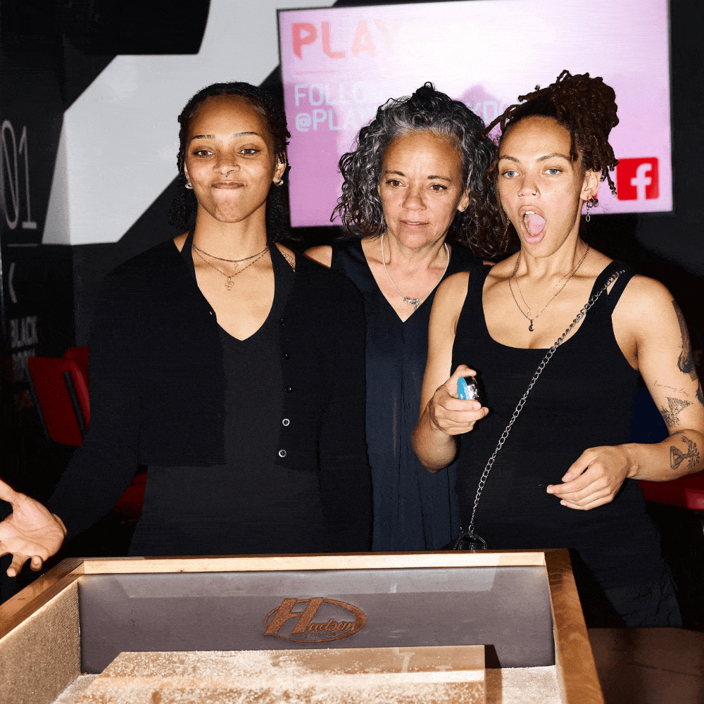 Customers playing Shuffleboard at PLAYBOX in Croydon