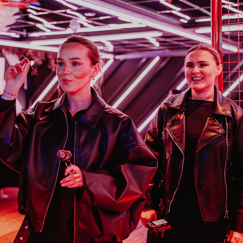 Two guests playing smart darts at PLAYBOX in Croydon