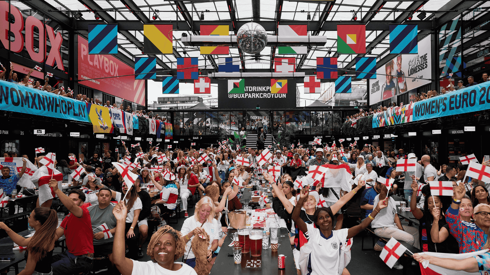 Guests watching football at BOXPARK