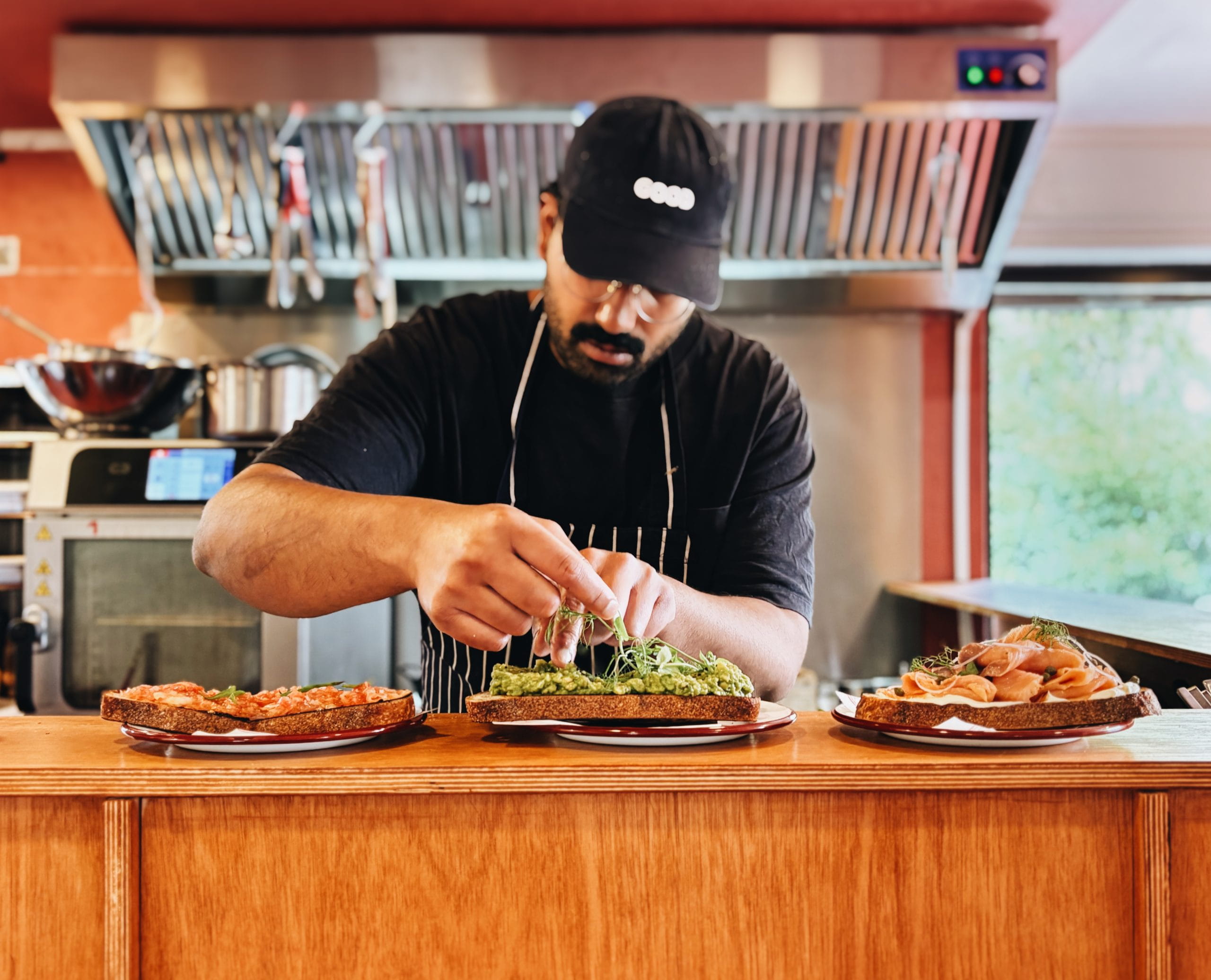 A chef assembling a sandwich at Earl's at Boxpark Shoreditch