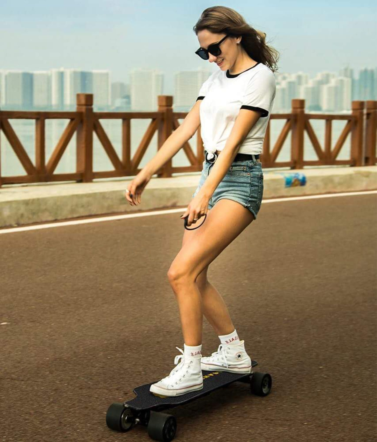 A girl riding an electric skateboard