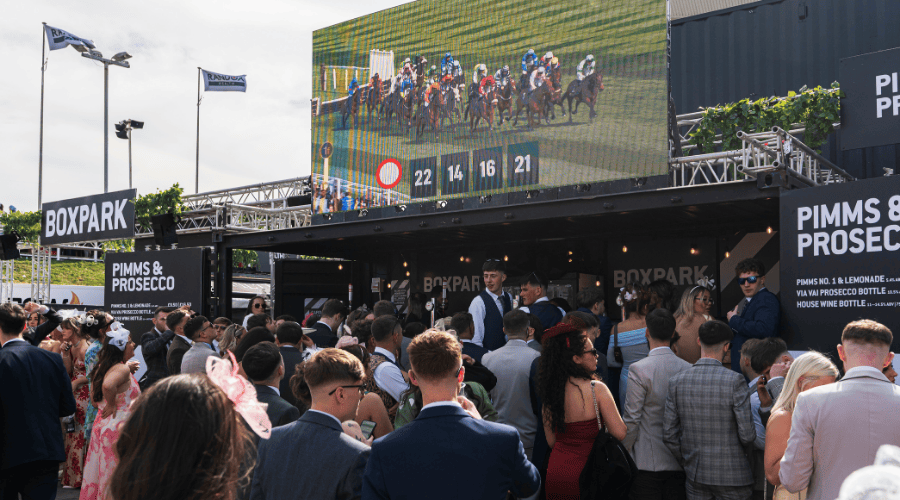 Guests watching the racing at the BOXPARK pop up at Aintree