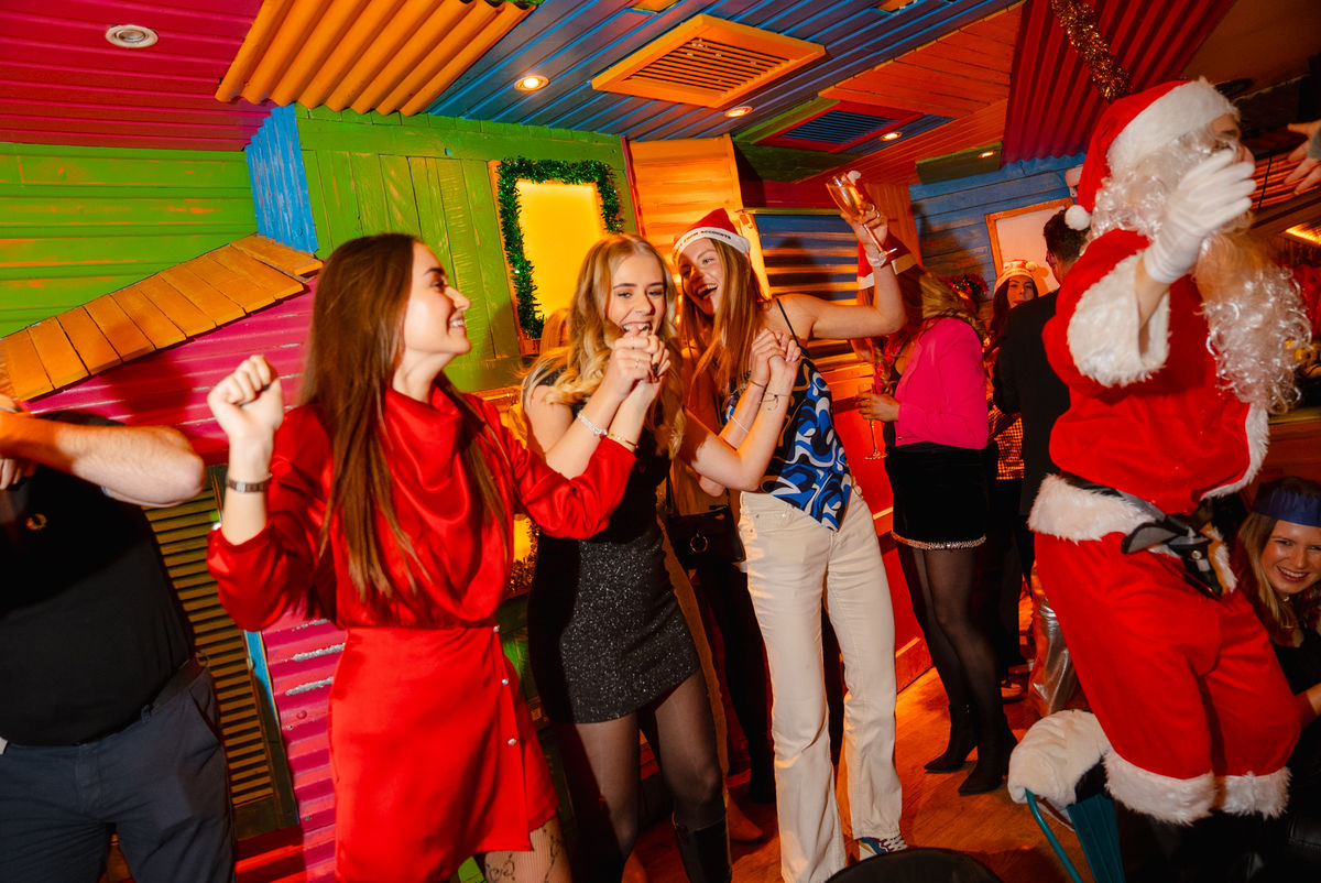 Women dancing at a Christmas bottomless brunch event in Barrio