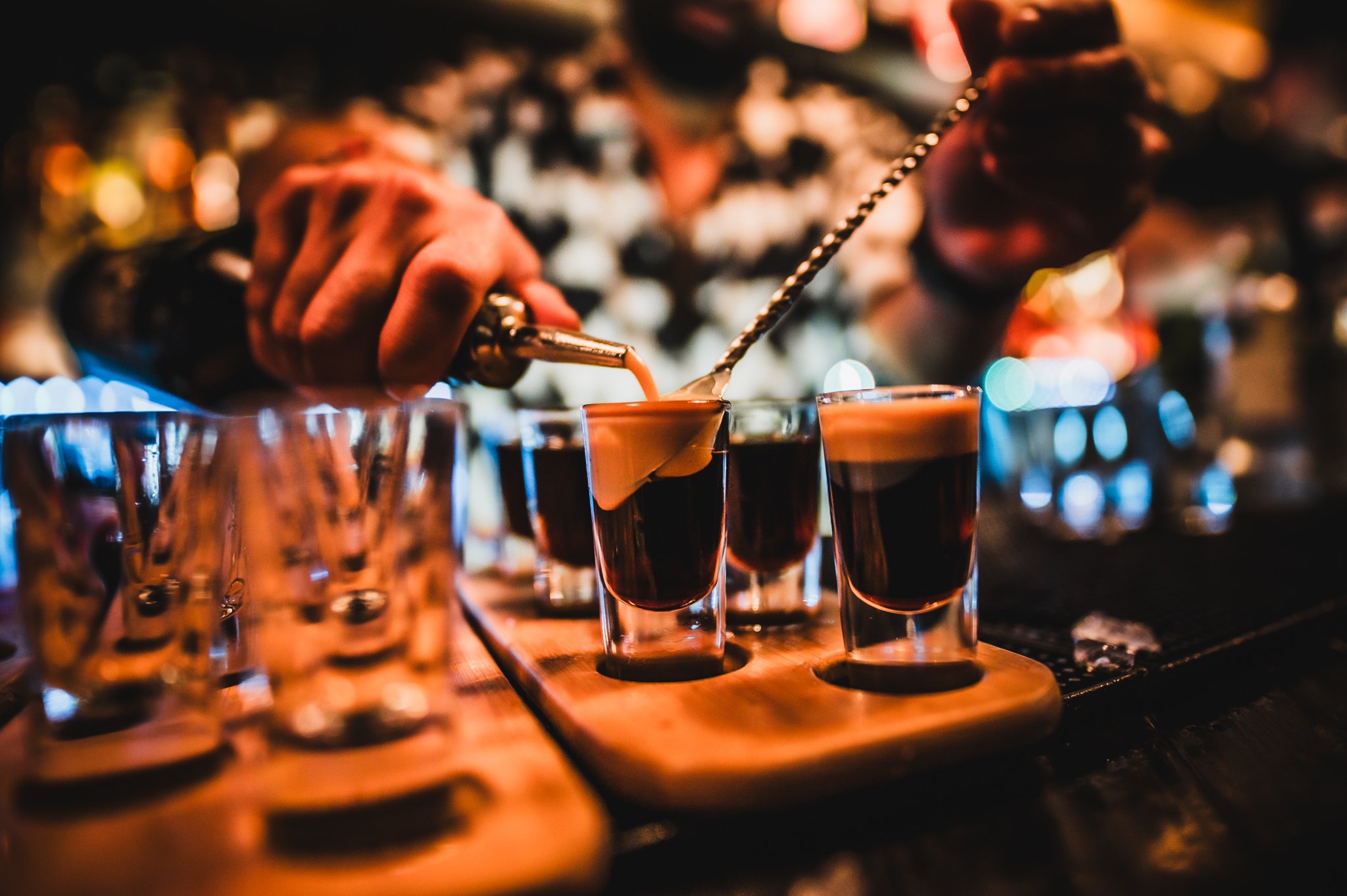 A bartender pouring a baby Guinness shot paddle 