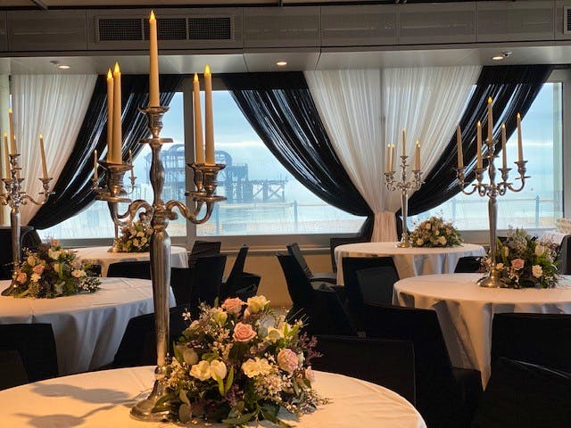A private room at Brighton i360 decorated with flowers and candelabras 