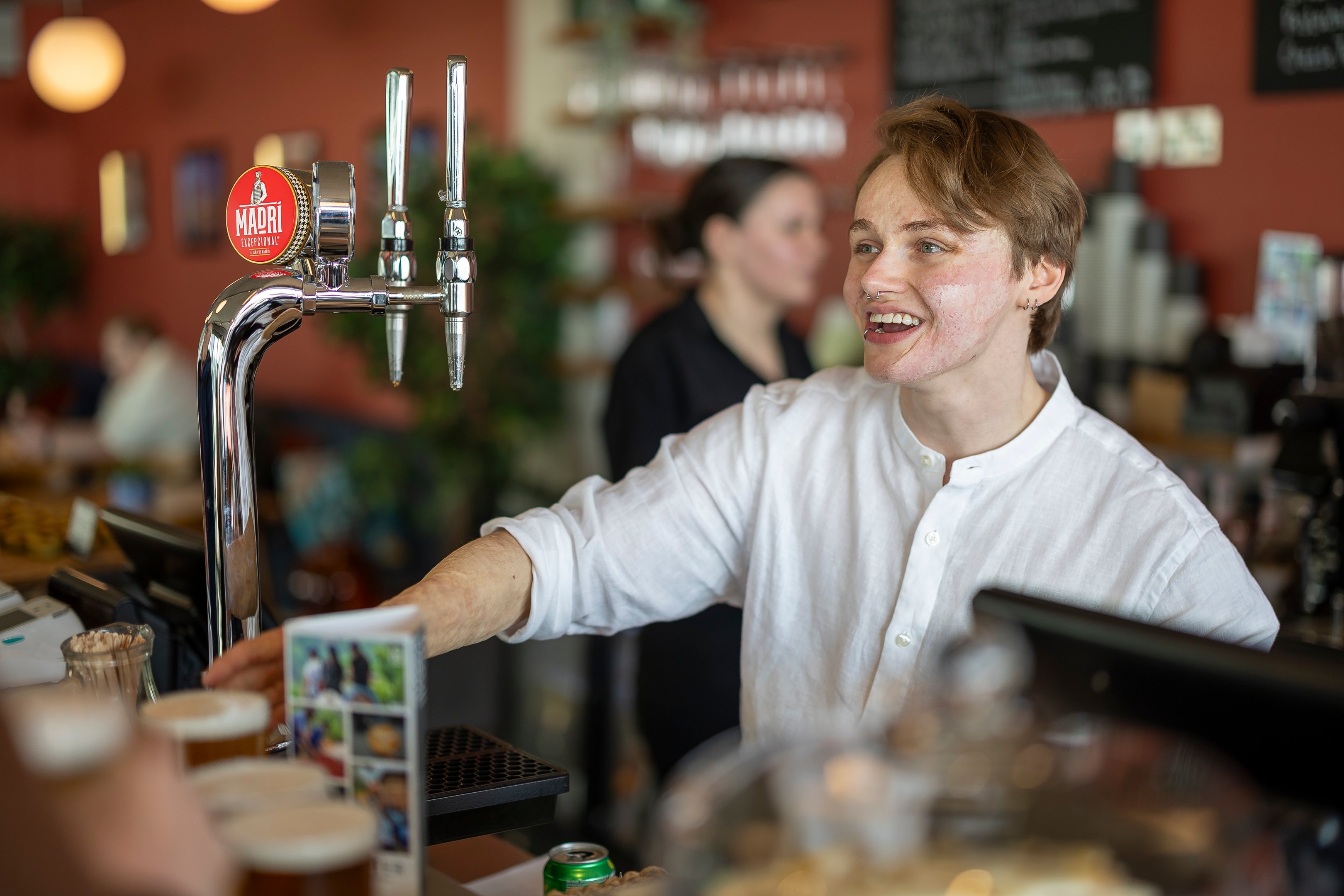A bartender serving a customer in the cafe at the Brighton i360