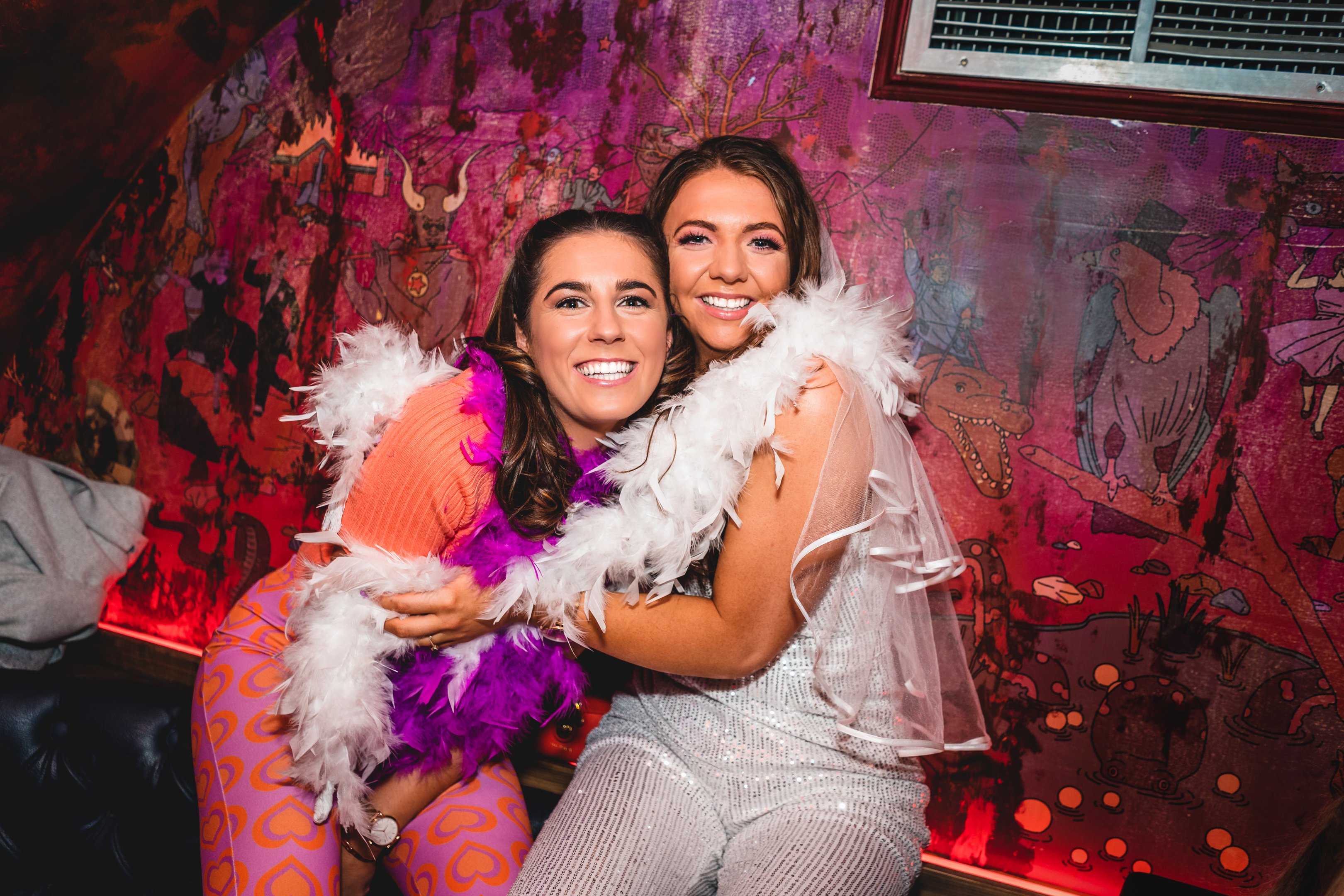 Two friends hugging and smiling in The Escapologist